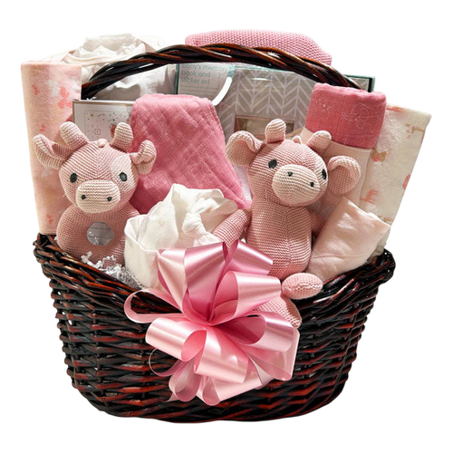 Baby Girl’s Basket of Love overflowing with pink blankets, giraffe plush, rattle and keepsakes in a dark wicker basket