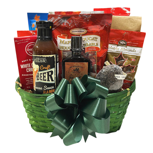 Gift basket titled Canadian Man featuring gourmet beer barbecue sauce, maple nougat, maple almonds, cookies, and other gourmet treats in a green woven basket with a dark green bow, ideal for birthday or corporate gifts delivered across Canada by Cherished Gift Baskets.