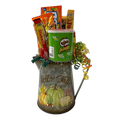 Fall Fun gift basket with caramel popcorn, Pringles, Fuzzy Peaches, Razzles, Toblerone, Lifesavers and Starburst in a metal pitcher planter.