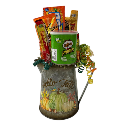 Fall Fun gift basket with caramel popcorn, Pringles, Fuzzy Peaches, Razzles, Toblerone, Lifesavers and Starburst in a metal pitcher planter.