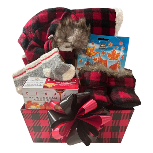 Gift basket with red and black plaid winter hat, cozy socks, maple cream cookies, maple leaf-themed treats, and matching plaid slippers with faux fur trim.